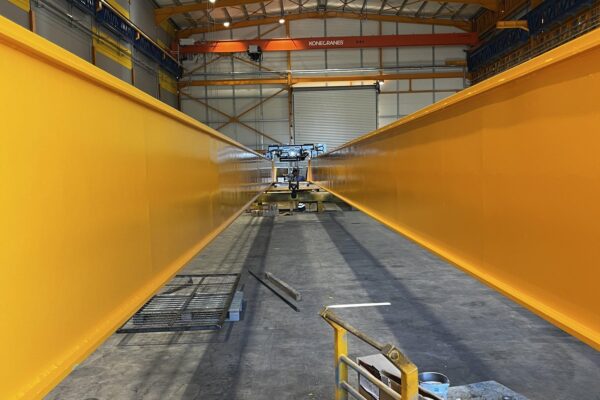 Fabricated crane girders viewed along their length in the workshop